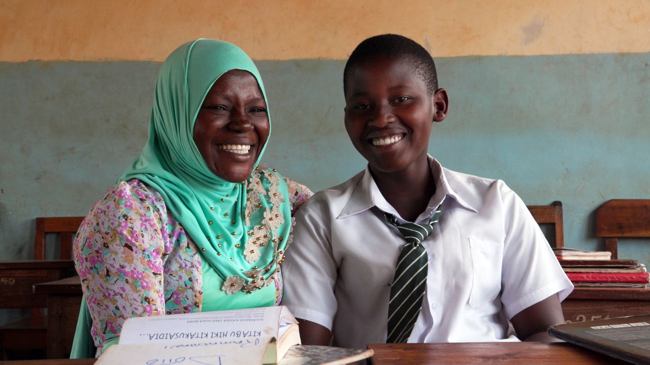 Dotto (left), a CAMFED Learner Guide, volunteers in her former school to mentor students like Hadijah (right) who is supported by CAMFED