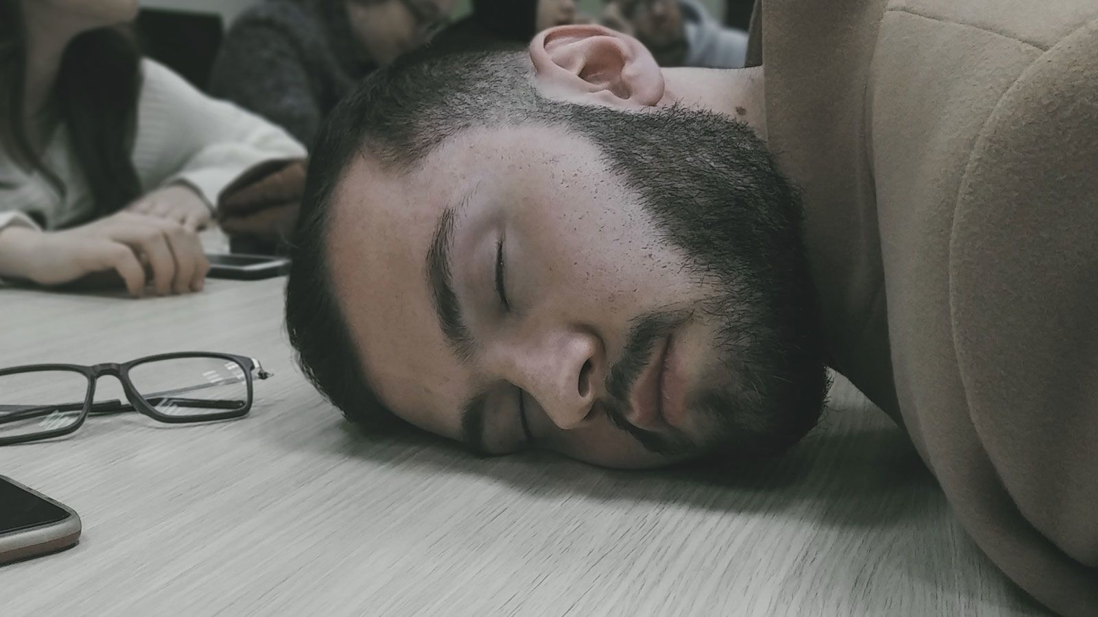 Burned out teacher sleeping on desk
